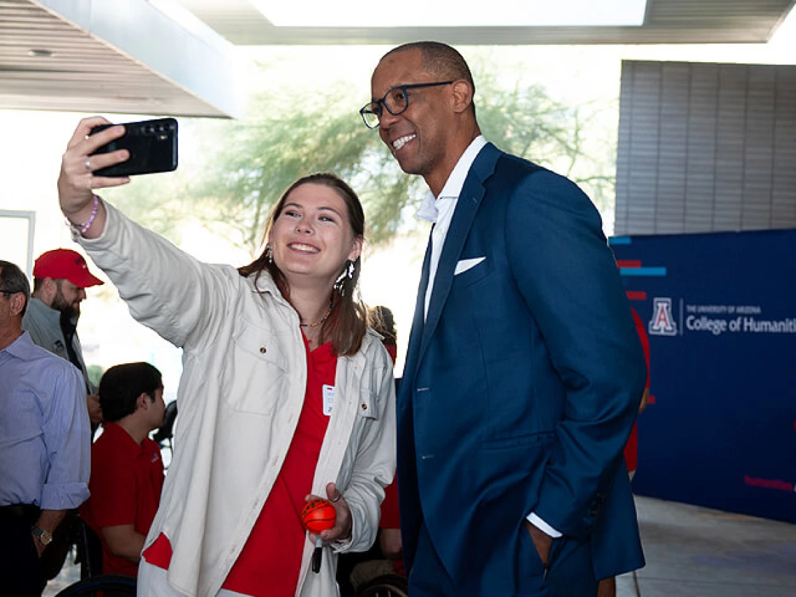 Woman taking a selfie with Sean Elliot